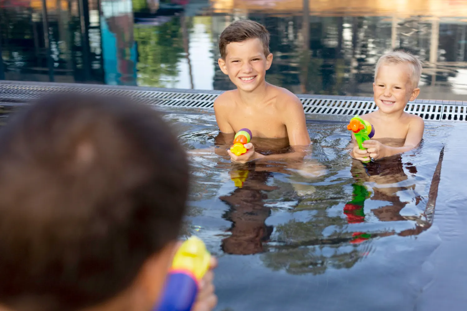 Family Play Water Gun at Swimming Pool